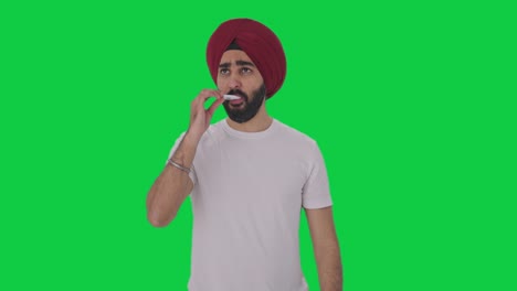 Kranker-Sikh-Indianer-Benutzt-Thermometer,-Um-Fieber-Auf-Grünem-Bildschirm-Zu-überprüfen
