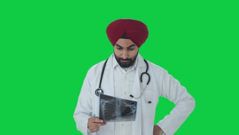 Stressed-Sikh-Indian-doctor-checking-X-ray-report-Green-screen