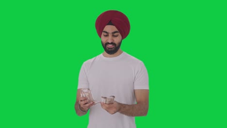 Happy-Sikh-Indian-man-counting-money-Green-screen