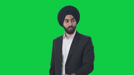 Angry-Sikh-Indian-businessman-shouting-on-employees-Green-screen
