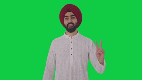 Sikh-Indianer-Zeigt-Siegeszeichen-Auf-Grünem-Bildschirm