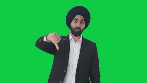 Disappointed-Sikh-Indian-businessman-showing-thumbs-down-Green-screen