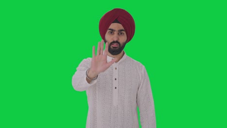 Sikh-Indianer-Hält-Jemanden-Auf-Grünem-Bildschirm-An