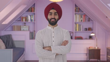 Happy-Sikh-Indian-man-standing-crossed-hands