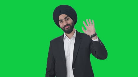 Happy-Sikh-Indian-businessman-saying-hello-Green-screen