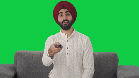 Sikh-Indischer-Mann-Vor-Dem-Fernseher,-Grüner-Bildschirm