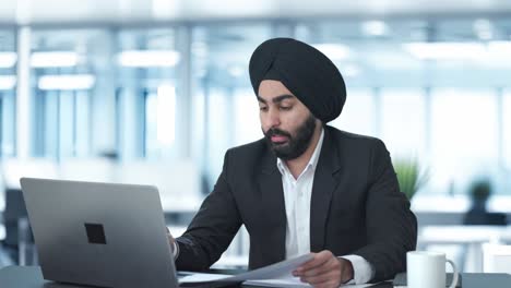 Sleepy-Sikh-Indian-businessman-working-on-Laptop