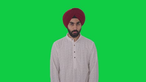 Guilty-Sikh-Indian-man-hiding-his-face-Green-screen