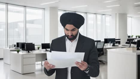 Frustrierter-Indischer-Sikh-Geschäftsmann,-Der-Unternehmensberichte-Liest