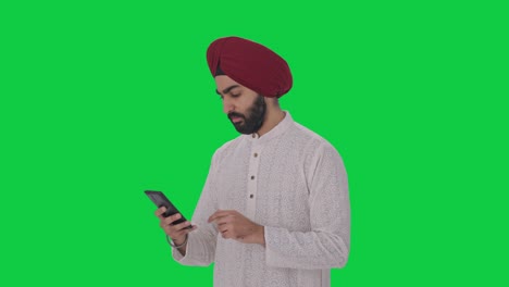 Hombre-Indio-Sij-Serio-Usando-La-Pantalla-Verde-Del-Teléfono