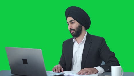 Sikh-Indian-businessman-doing-meeting-on-video-call-Green-screen