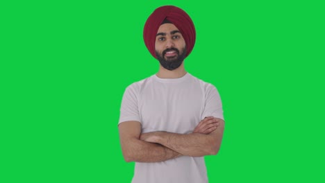 Fröhlicher-Sikh-Indianer,-Der-Mit-Gekreuzten-Händen-Auf-Grünem-Bildschirm-Steht