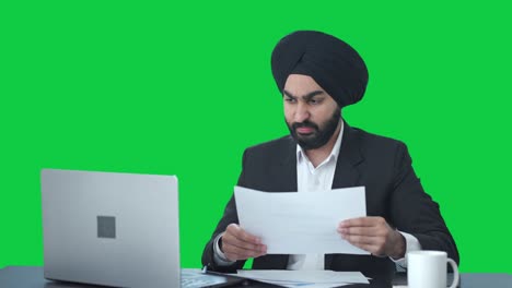 Angry-Sikh-Indian-businessman-working-on-Laptop-Green-screen