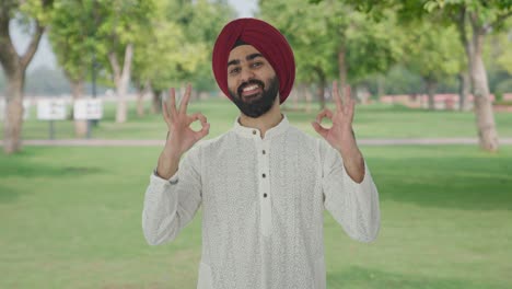 Happy-Sikh-Indian-man-showing-okay-sign-in-park