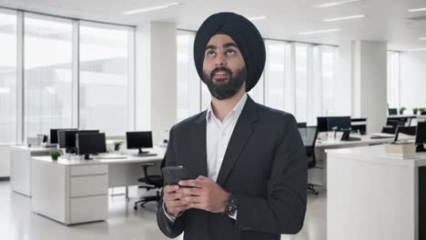 Happy-Sikh-Indian-businessman-texting-someone