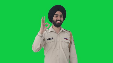 Happy-Sikh-Indian-police-man-showing-okay-sign-Green-screen