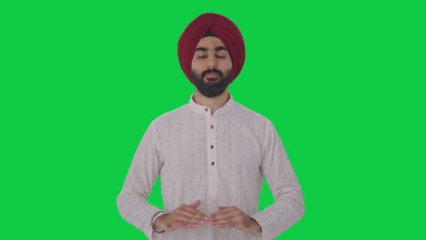 Hombre-Indio-Sikh-Haciendo-Yoga-Pantalla-Verde