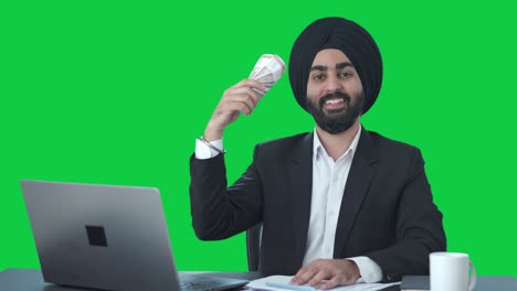 Happy-Sikh-Indian-businessman-using-money-as-fan-Green-screen