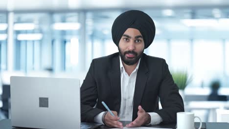 Happy-Sikh-Indian-businessman-talking-to-employees