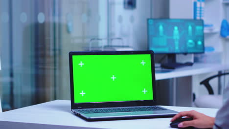 Healthcare-practitioner-using-laptop-with-green-screen