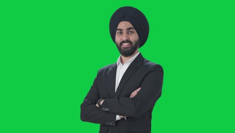 Porträt-Eines-Glücklichen-Indischen-Sikh-Geschäftsmanns,-Der-Mit-Gekreuzten-Händen-Auf-Grünem-Bildschirm-Steht