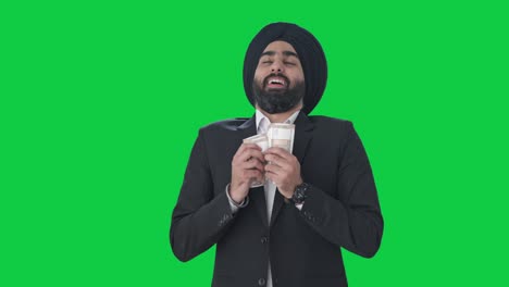 Happy-Sikh-Indian-businessman-counting-money-Green-screen