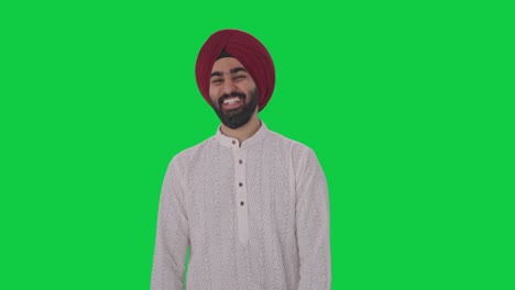 Sikh-Indian-man-laughing-on-someone-Green-screen
