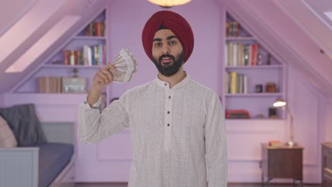 Egoistischer-Sikh-Indianer,-Der-Geld-Als-Fächer-Mit-Listigem-Lächeln-Verwendet