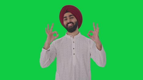 Happy-Sikh-Indian-man-showing-okay-sign-Green-screen