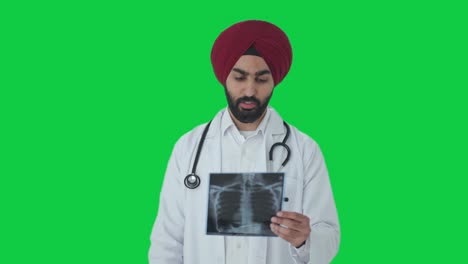 Serious-Sikh-Indian-doctor-checking-X-ray-report-Green-screen