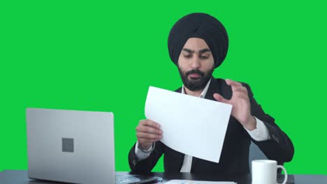 Sikh-Indian-businessman-working-on-Laptop-Green-screen