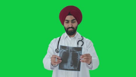 Happy-Sikh-Indian-doctor-checking-X-ray-report-Green-screen