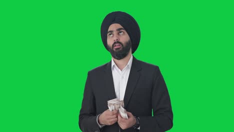 Empresario-Indio-Sikh-Contando-Dinero-En-Pantalla-Verde