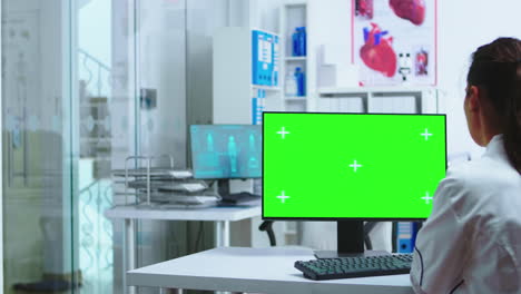 Doctor-specialist-using-computer-with-green-screen