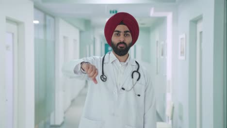 Disappointed-Sikh-Indian-doctor-showing-thumbs-down