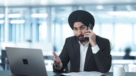 Serious-Sikh-Indian-businessman-talking-on-call