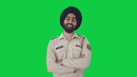 Happy-Sikh-Indian-police-man-standing-crossed-hands-Green-screen