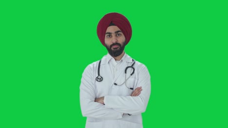 Confident-Sikh-Indian-doctor-standing-crossed-hands-Green-screen