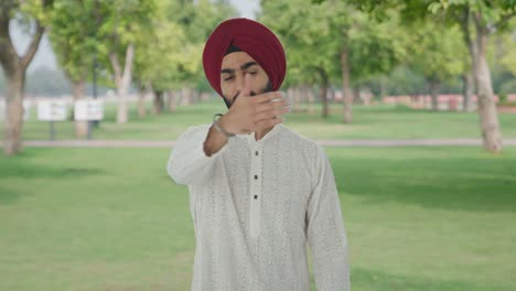 Angry-Sikh-Indian-man-stopping-someone-in-park
