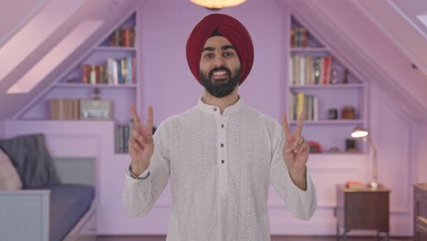 Happy-Sikh-Indian-man-showing-victory-sign