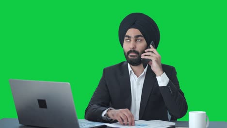 Sikh-Indian-businessman-talking-on-call-Green-screen