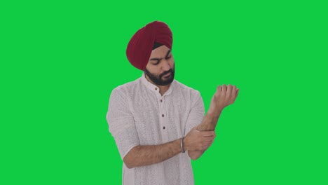 Hombre-Indio-Sikh-Enfermo-Que-Sufre-De-Dolor-En-La-Mano-Pantalla-Verde