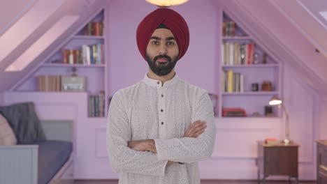 Confident-Sikh-Indian-man-standing-crossed-hands
