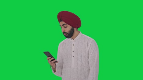 Fauler-Sikh-Indianer-Mit-Grünem-Telefonbildschirm