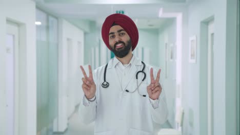 Happy-Sikh-Indian-doctor-showing-victory-sign
