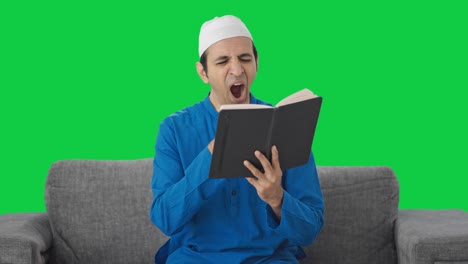 Lazy-Muslim-man-reading-book-and-drinking-tea-Green-screen