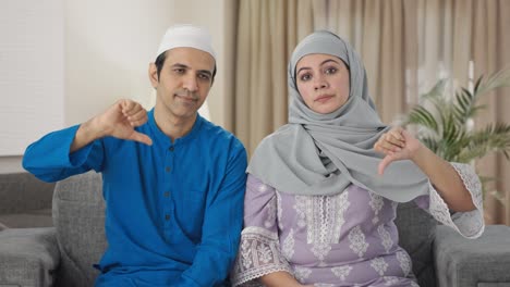Muslim-couple-showing-thumbs-down