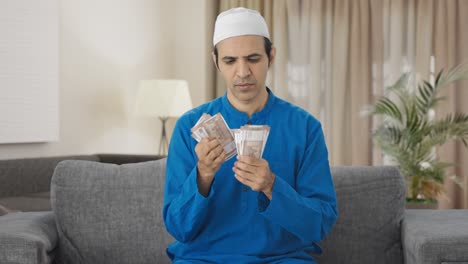 Hombre-Musulmán-Contando-Dinero-En-Casa