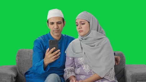 Angry-Muslim-couple-talking-their-child-on-video-call-Green-screen