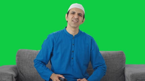 Frustrated-Muslim-man-watching-television-Green-screen
